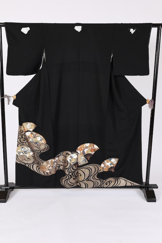 New, unused formal kimono (Tomesode). Black, gold, white, and gray. Rinpa style. Features include waves, fans, plum blossoms, chrysanthemums, grapes, maple leaves, and gold thread embroidery. Kyoto Yuzen dyeing. B1470