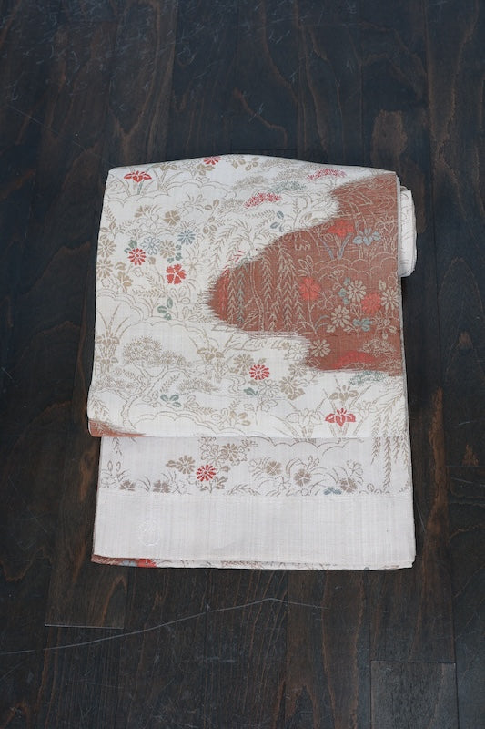 New, fukuro obi ( sash), made of silk floss, by Kawashima Textile, in beige, blue, brown, and red, featuring a floral and flowing water pattern (R220).
