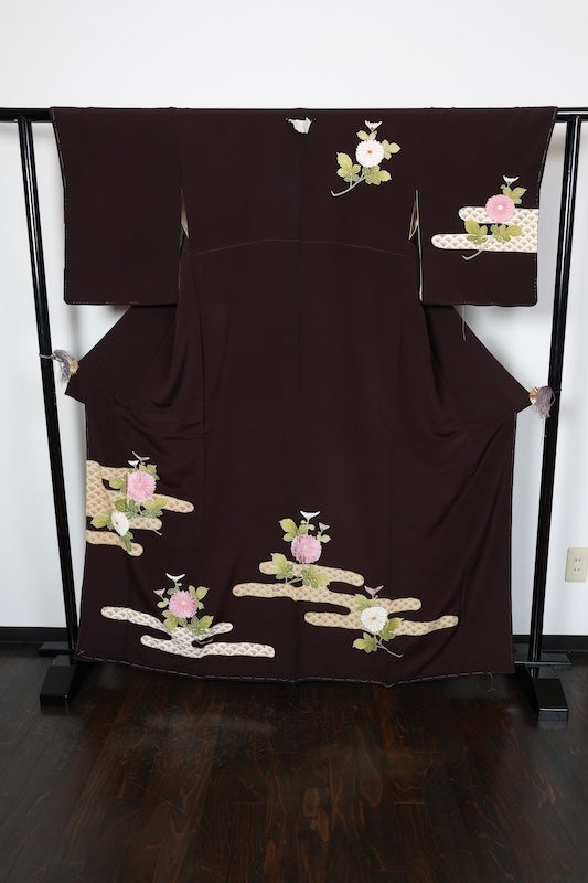 New, unused formal kimono (houmongi) in brown, green, beige, and white. Features gold thread embroidery, floral and wave patterns. (R72)