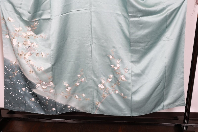 New, unused formal kimono (houmongi) in light blue, gold, brown, green, and white, with a continuous woven pattern of tachibana (mandarin orange) and children's motifs. (R90)