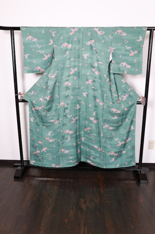 Japan used kimono fabric in light blue, brown, purple, indigo, and coral, with a floral pattern throughout. (R155)