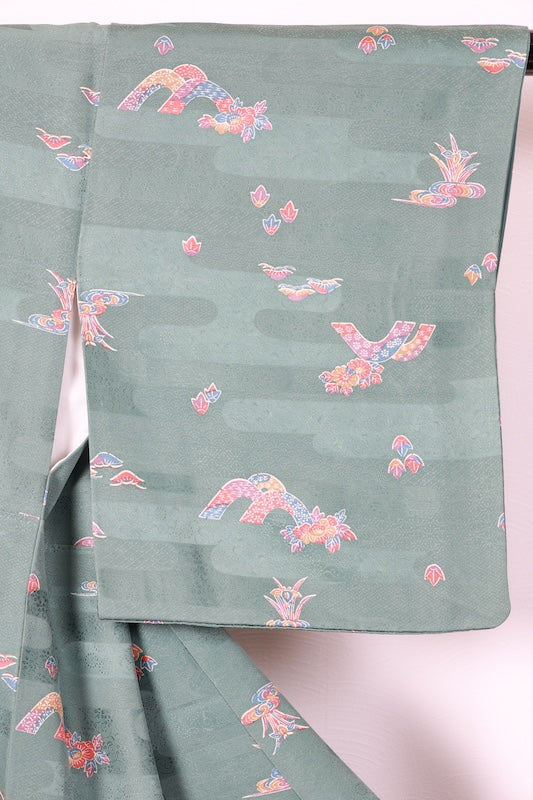 Japan used kimono fabric in light blue, brown, purple, indigo, and coral, with a floral pattern throughout. (R155)