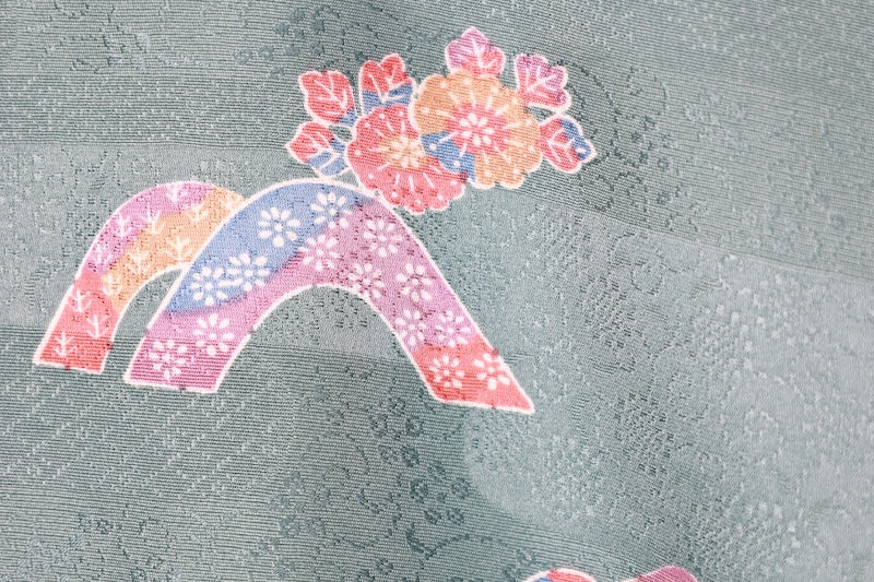 Japan used kimono fabric in light blue, brown, purple, indigo, and coral, with a floral pattern throughout. (R155)