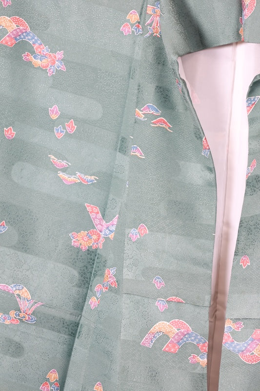 Japan used kimono fabric in light blue, brown, purple, indigo, and coral, with a floral pattern throughout. (R155)