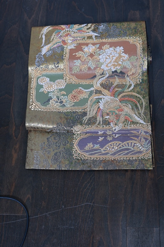 New, unstitched fukuro obi (formal sash). Gold, purple, black, and white. Features phoenixes, butterflies, and flowers. R231