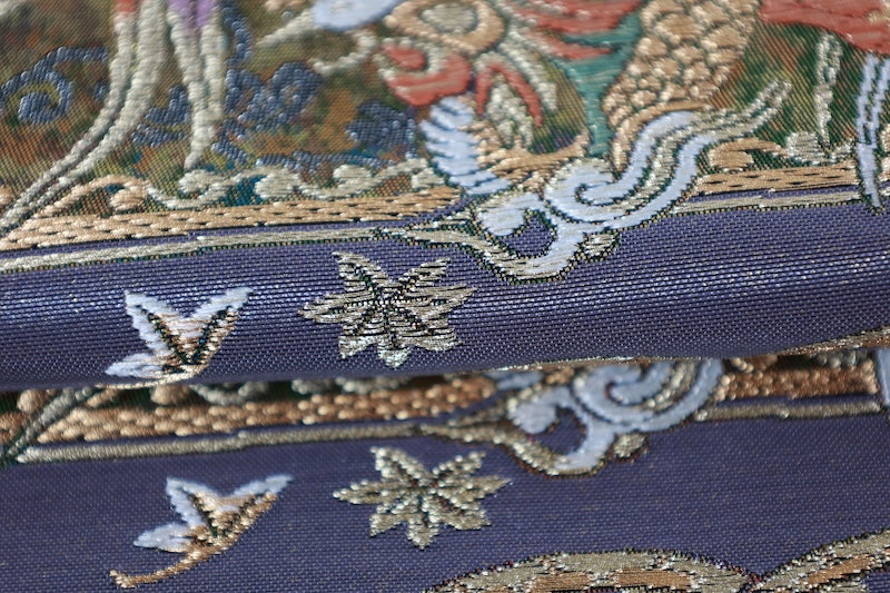 New, unstitched fukuro obi (formal sash). Gold, purple, black, and white. Features phoenixes, butterflies, and flowers. R231