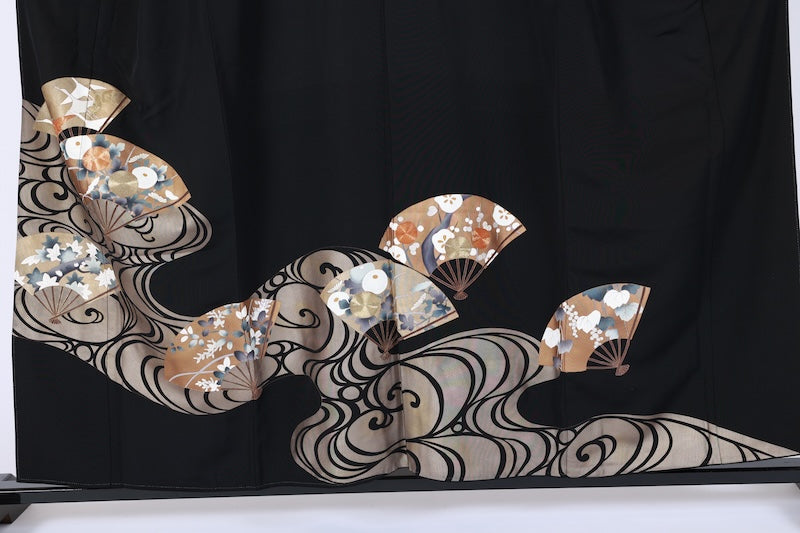 New, unused formal kimono (Tomesode). Black, gold, white, and gray. Rinpa style. Features include waves, fans, plum blossoms, chrysanthemums, grapes, maple leaves, and gold thread embroidery. Kyoto Yuzen dyeing. B1470