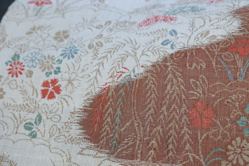 New, fukuro obi ( sash), made of silk floss, by Kawashima Textile, in beige, blue, brown, and red, featuring a floral and flowing water pattern (R220).