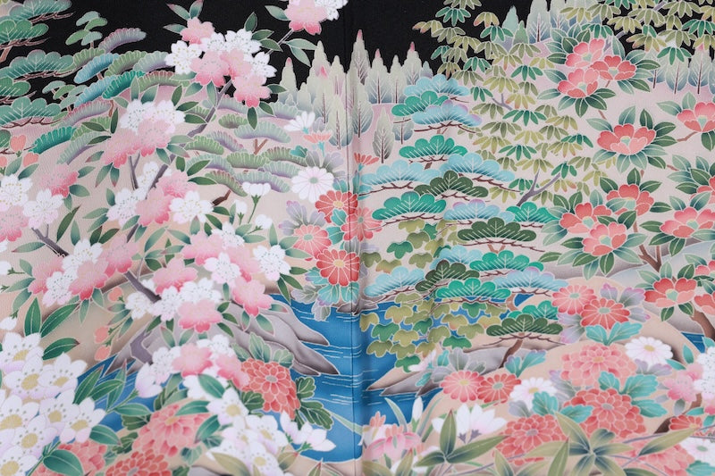 Black formal kimono used (Kurotomesode) with five crests and a four-diamond pattern. Colors: green, indigo, cherry blossom pink, gray, beige. Features a traditional landscape design. Kyoto Yuzen dyeing technique. J8