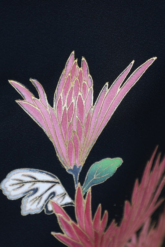 Black formal kimono used (Kurotomesode) with plum blossom design, gold, gray, ochre, coral, shades of green, gold thread embroidery, bamboo fence, and flowers. Artist-made. L46