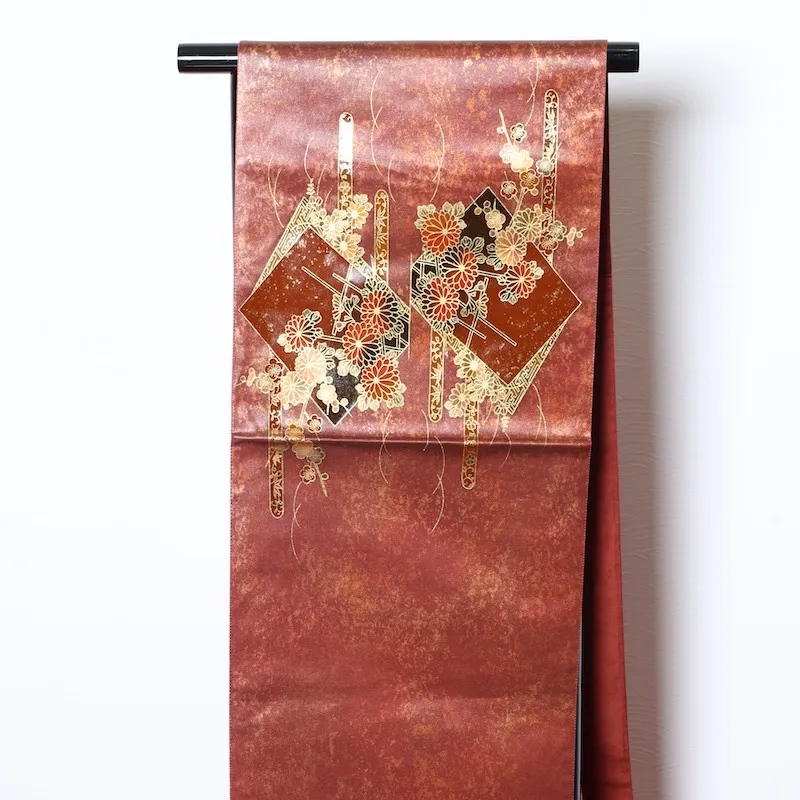 Fukuro obi　used (formal sash), lacquer and gold leaf, plum blossoms, chrysanthemums, cherry blossoms, seigaiha (wave pattern), flower cart, rust-red, tataki (stamped) finish, taiko (drum-shaped) pattern, P