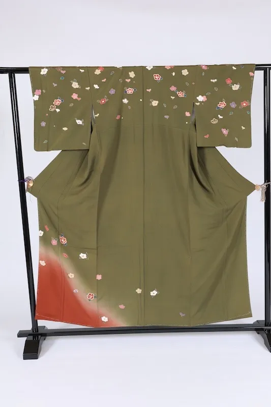 New, unused formal kimono (houmongi) in green, purple, white, red, blue, and gold, featuring camellia and cherry blossom patterns. (G10)