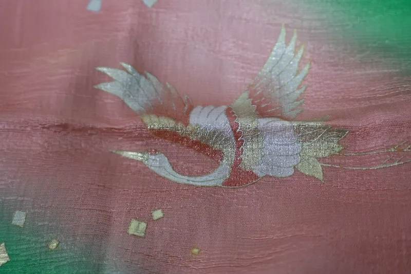 used Stole: Cherry-blossom pink, green, gold, and silver; featuring a crane motif and an all-over woven pattern (R348).